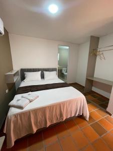 a bedroom with a large bed in a room at Hotel Valle Central in Valledupar