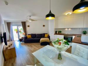 a living room with a couch and a table with a vase at MARISOL beautiful apartment with oceanview in Adeje