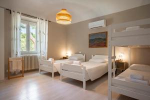 a bedroom with two bunk beds and a chandelier at Agriturismo Terre della Rinascita in Castelnuovo della Misericordia
