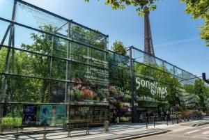 a glass building with signs on the side of it at Charming Apartment with Eiffel Tower View in Paris