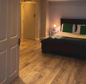 a bedroom with a bed and a wooden floor at The Nash Suite - one minute walk to beach in Brighton & Hove