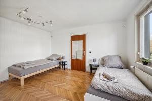 a bedroom with two beds and a wooden floor at home2stay worker Apartments Nürtingen-Zizishausen Ap1 in Nürtingen