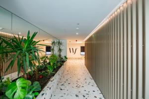 a hallway of an office building with plants at Waterfront Luxury Residence - Paid Parking Option in Budapest