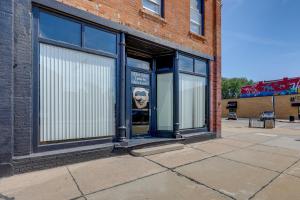 a store front with its doors open on a street at Cozy Abode in Historic Yankton - Heart of the City in Yankton