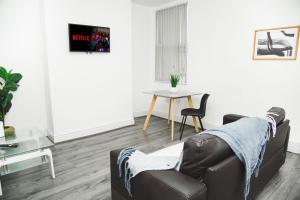 a living room with a couch and a table at Modern Central Oasis in Liverpool