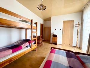 a bedroom with two bunk beds and a desk at Promyk in Władysławowo