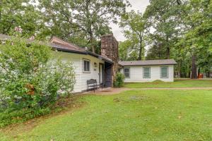 a white house with a stone chimney and a yard at Updated Afton Cottage with Dock and Lake Access! in Afton