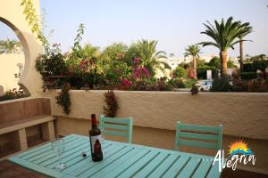 a bottle of wine sitting on a table on a patio at Captivating 2-Bed Beachside Apartment in Mojacar in La Marina de la Torre