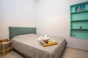 a bedroom with a bed with a tray of towels at Art house old town in Rhodes Town