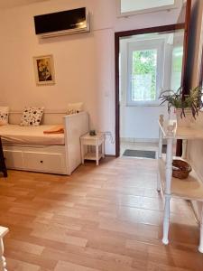 a small room with a bed and a window at Apartments Fina in Crikvenica