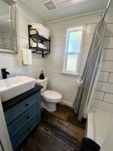 a bathroom with a toilet and a sink and a window at Resort at Fredericksburg Unit 1 in Rocky Hill