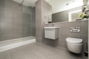 a bathroom with a white toilet and a shower at Brand New 2 bedroom apartment Centre of Solihull in Solihull