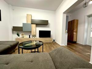 a living room with a couch and a table at XOX Villa House & Garden Bucharest in Bucharest