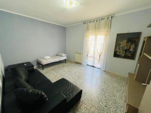 a living room with a couch and a bed at Darsena Fiumicino in Fiumicino