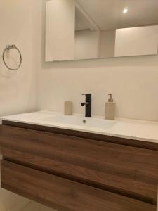 a bathroom with a sink and a mirror at Stunning 2 Bedroom garage & balcony in Lisbon