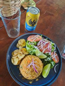 a blue plate of food with a sandwich and salad at Garza del Sol Glamping Río Celeste Bromelia in San Rafael