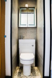 a small bathroom with a toilet and a window at Cozy Retreat in the Heart of Liverpool in Liverpool