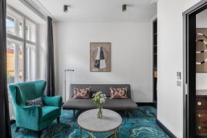 a living room with a couch and a table at numa I Republika Rooms & Apartments in Prague