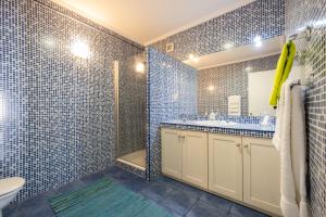 a bathroom with a shower and a toilet and a sink at Furnas Millhouse in Furnas