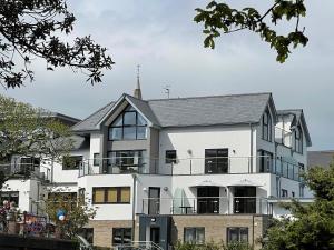 a white building with a black roof at BayVue Apartment & Apartment 7, The Bay House in Shanklin