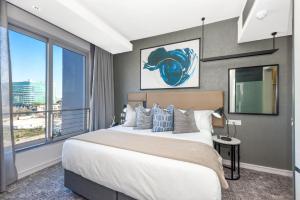 una camera con un grande letto e una grande finestra di Chic Apartment in 5 star hotel a Johannesburg