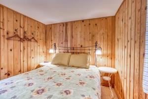 a bedroom with wood paneled walls and a bed at Hidden Villa Cottages #4, #5, and #6 in Cannon Beach