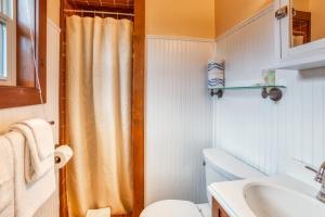 a bathroom with a shower curtain and a toilet at Hidden Villa Cottages #4, #5, and #6 in Cannon Beach +25 photos