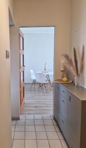 a kitchen with a view of a dining room with a table at Lato Nad Morzem II Gdańsk Brzeźno in Gdańsk