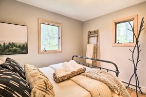 a bedroom with a bed and two windows at Serene Hideaway with Views, 1 Mi to Hike and Ski! in Wintergreen