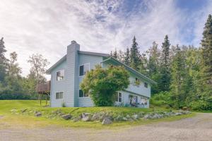a house in the middle of a field at Cozy Anchorage Vacation Rental with Deck, Gas Grill in Anchorage