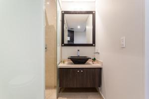 a bathroom with a sink and a mirror at Soy Local Usaquen in Bogotá