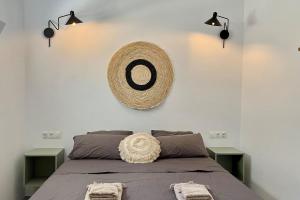 a bedroom with a bed with two green end tables at Casita Malacitano, Caminito del Rey in Valle de Abdalagís +18 photos