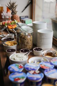 a table with bowls of food and jars of food at Wake Up Wellness Hostel in Brno