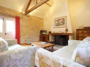 a living room with two couches and a fireplace at The Granary in Cheltenham