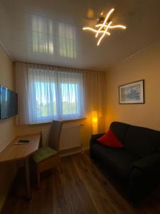 a living room with a couch and a table at Zum Hanseaten in Borkum