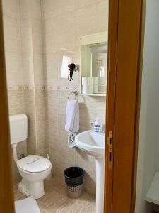 a small bathroom with a toilet and a sink at Hotel Perjanik in Danilovgrad