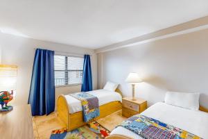 a bedroom with two beds and a window at Emerald Surf 502 in Navarre +19 photos