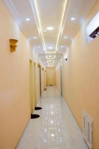 a corridor of a hallway with a long hallway at Family Inn in İsmayıllı