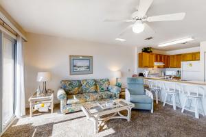 a living room with a couch and a kitchen at Island Sands 306 in Fort Walton Beach