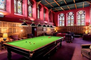 a room with a pool table and stained glass windows at LOCH NESS - Luxury Highland Retreat in Scotland in Fort Augustus