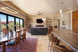 a kitchen and living room with a large table and chairs at Red Rock Wonder in St. George