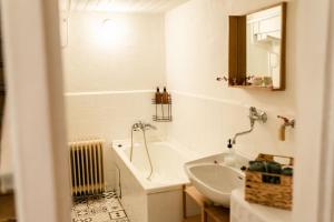 a white bathroom with a tub and a sink at Chalupa pod vysokou in Ludvíkov +26 photos