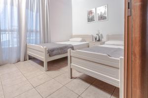 Posteľ alebo postele v izbe v ubytovaní Mike's Apartments