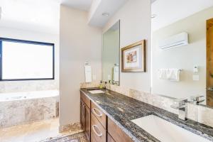 a bathroom with two sinks and a large mirror at Red Rock Wonder in St. George +34 photos