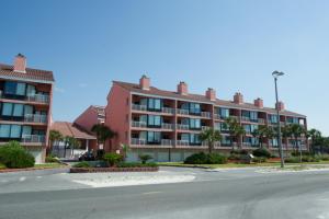 an empty street in front of a large building at Palm Beach Club 2-225 in Pensacola Beach