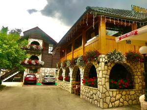 a building with flowers on the side of it at Villa Miris Dunja in Zlatibor