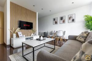 a living room with a couch and a table at Luxury 2-bed In central MK By Valore Property Services in Milton Keynes