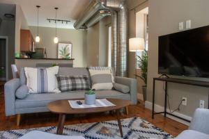 a living room with a couch and a tv at Huge Parkside Retreat - Private Roof Decks in Cincinnati