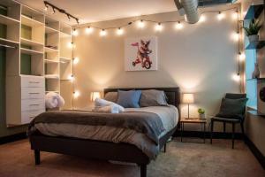 a bedroom with a bed with lights on the wall at Huge Parkside Retreat - Private Roof Decks in Cincinnati +48 photos