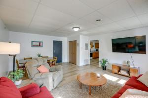 a living room with a couch and a table at Bright Yankton Apartment Near Meridian Bridge in Yankton